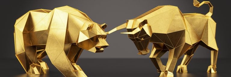 Fighting golden figures of a bear and a bull
